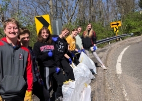 kids holding trash bags